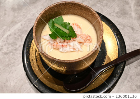 A piping hot chawanmushi topped with a generous amount of crab meat A piping hot chawanmushi topped with a generous amount of crab meat 136001136