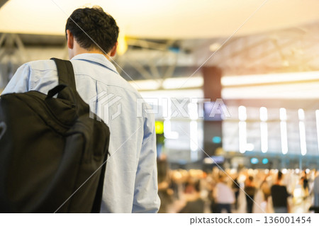 A man carrying a backpack at the airport. Photo courtesy of Kansai International Airport (KIX). 136001454