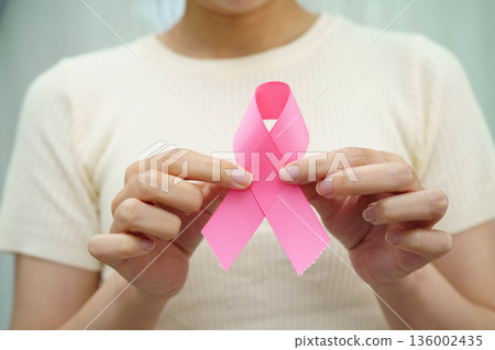 Asian woman with pink ribbon for October world breast cancer day. 136002435