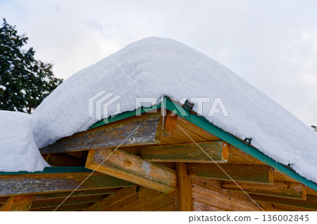 Snow and icicles on the roof 136002845