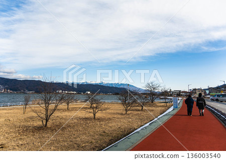 Walking along the promenade along Lake Suwa in winter Walking along the promenade along Lake Suwa in winter 136003540
