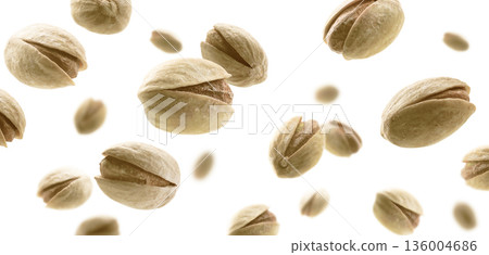 Salted pistachios levitate on a white background 136004686