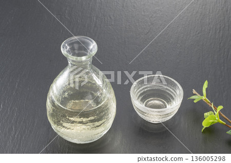 Cold sake and chilled sake placed in a sake cup on a black background Cold sake and chilled sake placed in a sake cup on a black background 136005298