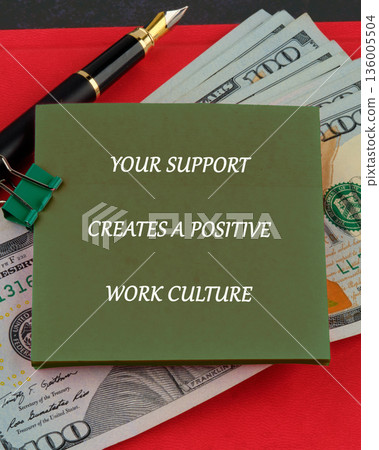 A green sticky note featuring the text YOUR SUPPORT CREATES A POSITIVE WORK CULTURE rests on several 100 US Dollar bills A green sticky note featuring the text YOUR SUPPORT CREATES A POSITIVE WORK CULTURE rests on several 100 US Dollar bills 136005504