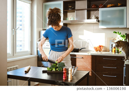 Preparing smashed broccoli with cheese in a kitchen during the afternoon Preparing smashed broccoli with cheese in a kitchen during the afternoon 136006198