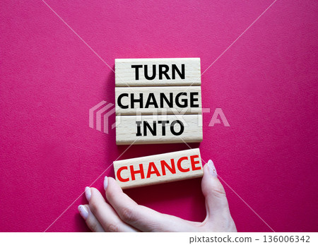 Change and Chance symbol. Concept words Turn Change Into Chance on wooden blocks. Beautiful bright red background. Businessman hand. Business and Turn Change Into Chance concept. Copy space. 136006342