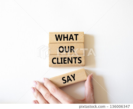 Clients symbol. Concept words What our Clients Say on wooden blocks. Beautiful bright white background. Businessman hand. Business and What our Clients Say concept. Copy space. Clients symbol. Concept words What our Clients Say on wooden blocks. Beautiful bright white background. Businessman hand. Business and What our Clients Say concept. Copy space. 136006347