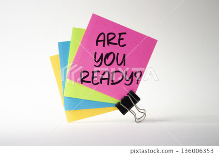 Are you ready symbol. Concept word Are you ready on pink sticky note with paper clips. Beautiful white background. Business and Are you ready concept. Copy space Are you ready symbol. Concept word Are you ready on pink sticky note with paper clips. Beautiful white background. Business and Are you ready concept. Copy space 136006353