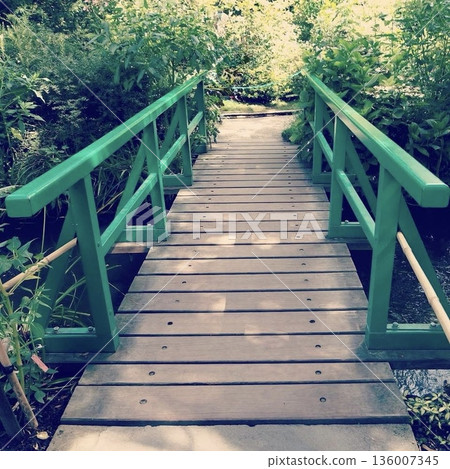 Giverny, France: A green Japanese-style bridge and lush green scenery in Monet's garden Giverny, France: A green Japanese-style bridge and lush green scenery in Monet's garden 136007345
