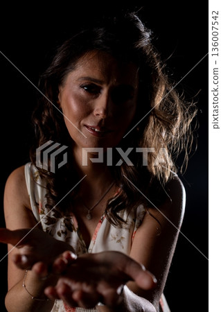 Lady showing kindness, Girl presenting her hands in trusting and compassionate manner, Woman offers her supportive hands with tender facial expression and soft lighting Lady showing kindness, Girl presenting her hands in trusting and compassionate manner, Woman offers her supportive hands with tender facial expression and soft lighting 136007542