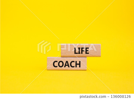 Life Coach symbol. Concept word Life Coach on wooden blocks. Beautiful yellow background. Business and Life Coach concept. Copy space Life Coach symbol. Concept word Life Coach on wooden blocks. Beautiful yellow background. Business and Life Coach concept. Copy space 136008126