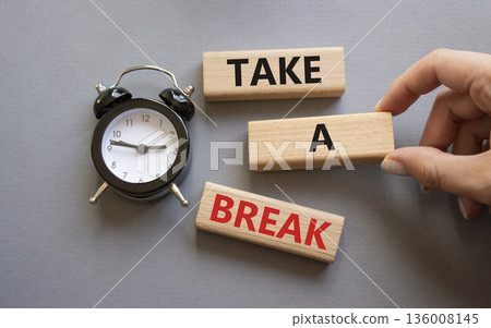 Take a break symbol. Concept words Take a break on wooden blocks. Businessman hand. Beautiful grey background with alarm clock. Business and Take a break concept. Copy space. 136008145