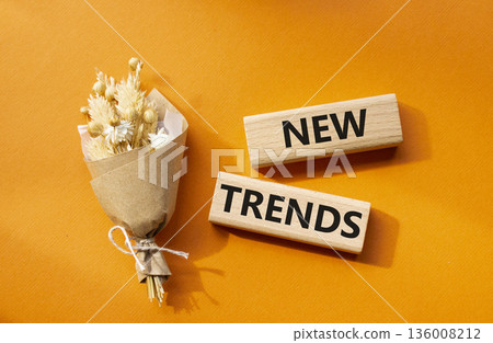 New Trends symbol. Wooden blocks with words New Trends. Beautiful orange background. Business and New Trends concept. Copy space. New Trends symbol. Wooden blocks with words New Trends. Beautiful orange background. Business and New Trends concept. Copy space. 136008212