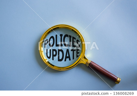 Policies Update symbol. Magnifying Glass with words Policies Update. Beautiful blue background. Business and Policies Update concept. Copy space. 136008269
