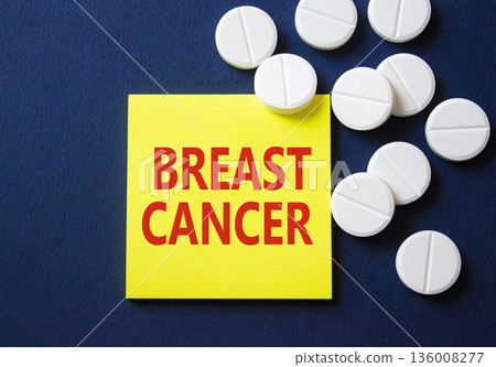 Breast cancer symbol. Concept word Breast cancer on yellow note. Beautiful deep blue background with pills. Medicine and Breast cancer concept. Copy space Breast cancer symbol. Concept word Breast cancer on yellow note. Beautiful deep blue background with pills. Medicine and Breast cancer concept. Copy space 136008277