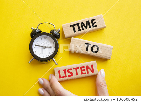 Time to listen symbol. Concept words Time to listen on wooden blocks. Businessman hand. Beautiful yellow background with alarm clock. Business and Time to listen concept. Copy space. Time to listen symbol. Concept words Time to listen on wooden blocks. Businessman hand. Beautiful yellow background with alarm clock. Business and Time to listen concept. Copy space. 136008452