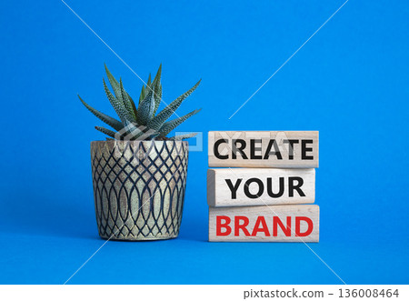Brand symbol. Concept words Create your Brand on wooden blocks. Businessman hand. Beautiful blue background with succulent. Business and Create your Brand concept. Copy space. Brand symbol. Concept words Create your Brand on wooden blocks. Businessman hand. Beautiful blue background with succulent. Business and Create your Brand concept. Copy space. 136008464