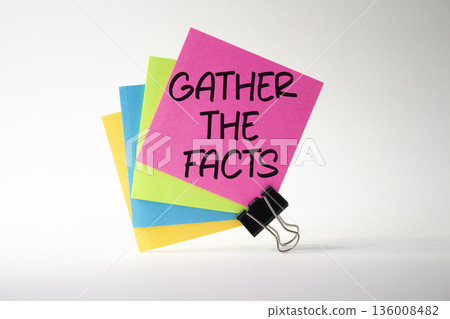 Gather the facts symbol. Pink sticky note with paper clips with words Gather the facts. Beautiful deep blue background. Business and Gather the facts concept. Copy space. 136008482