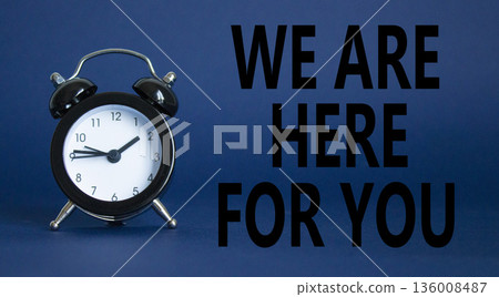 Help symbol. Wooden blocks with words We are here for you. Beautiful deep blue background with alarm clock. Business and We are here for you concept. Copy space. Help symbol. Wooden blocks with words We are here for you. Beautiful deep blue background with alarm clock. Business and We are here for you concept. Copy space. 136008487