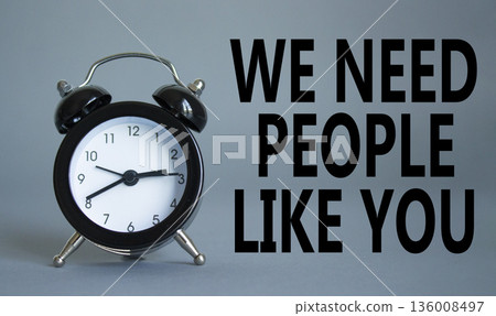 Hiring symbol. Wooden blocks with words We need People like You. Beautiful grey background with alarm clock. Business and Hiring concept. Copy space. 136008497