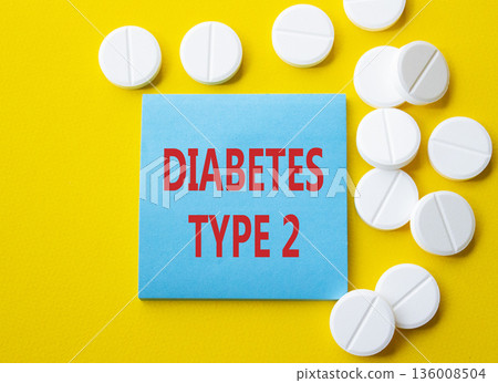 Diabetes Type 2 symbol. Concept word Diabetes Type 2 on blue note. Beautiful yellow background with pills. Medicine and Diabetes Type 2 concept. Copy space Diabetes Type 2 symbol. Concept word Diabetes Type 2 on blue note. Beautiful yellow background with pills. Medicine and Diabetes Type 2 concept. Copy space 136008504