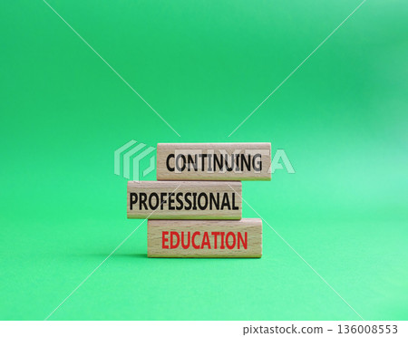 Continuing Education symbol. Concept words Continuing Professional Education on wooden blocks. Beautiful bright green background. Business and Education concept. Copy space 136008553