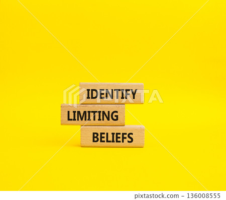 Limiting Beliefs symbol. Concept word Identify Limiting Beliefs on wooden blocks. Beautiful yellow background. Business and Limiting Beliefs concept. Copy space 136008555