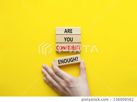 Confidence symbol. Concept words Are you confident enough wooden blocks. Beautiful bright yellow background. Businessman hand. Business and Are you confident enough concept. Copy space. Confidence symbol. Concept words Are you confident enough wooden blocks. Beautiful bright yellow background. Businessman hand. Business and Are you confident enough concept. Copy space. 136008562