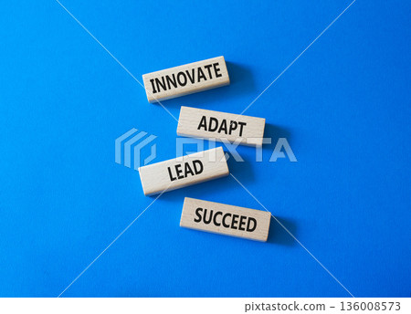 Innovate Adapt Lead Succeed symbol. Concept words Innovate Adapt Lead Succeed on wooden blocks. Beautiful bright blue background. Business and Innovate Adapt Lead Succeed concept. Copy space. 136008573