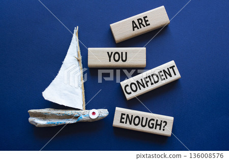 Confidence symbol. Wooden blocks with words Are you confident enough. Beautiful deep blue background with boat. Business and Are you confident enough concept. Copy space. 136008576