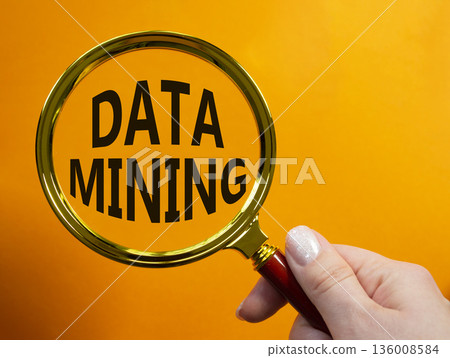 Data Mining symbol. Magnifying Glass with words Data Mining. Beautiful orange background. Businessman hand. Business and Data Mining concept. Copy space. Data Mining symbol. Magnifying Glass with words Data Mining. Beautiful orange background. Businessman hand. Business and Data Mining concept. Copy space. 136008584