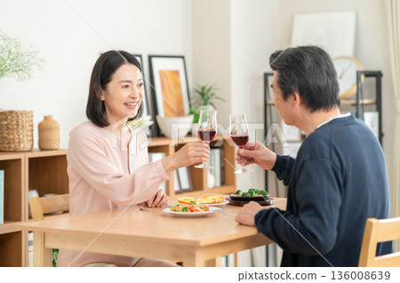 A middle-aged couple having a meal at home 136008639