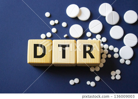 DTR symbol. Wooden cubes with words DTR Deep tendon reflexes. Beautiful deep blue background. Healthcare and Deep tendon reflexes concept. Copy space. 136009003