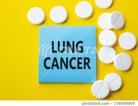 Lung Cancer symbol. Concept word Lung Cancer on blue note. Beautiful yellow background with pills. Medicine and Lung Cancer concept. Copy space 136009009