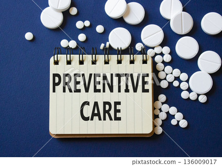Preventive Care symbol. Concept word Preventive Care on notebook. Beautiful deep blue background with pills. Medicine and Preventive Care concept. Copy space 136009017