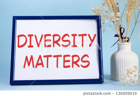Diversity matters symbol. Concept words Diversity matters on beautiful wooden picture frame. Beautiful light blue background with flower vase. Business and Diversity matters concept. Copy space. 136009019