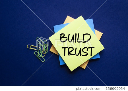 Build trust symbol. Build trust on sticky note. Beautiful deep blue background. Business and Build trust concept. Copy space. Build trust symbol. Build trust on sticky note. Beautiful deep blue background. Business and Build trust concept. Copy space. 136009034