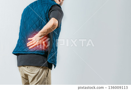 Person with pain holding his lower back isolated. Male person with spine problems, Lumbar problems concept Person with pain holding his lower back isolated. Male person with spine problems, Lumbar problems concept 136009113