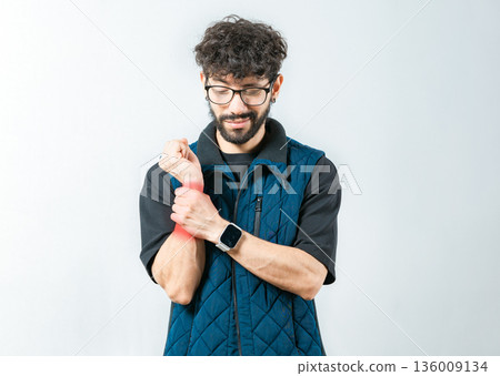 Person with wrist pain and arthritis isolated. Young man with arthritis isolated.. Wrist pain and arthritis concept 136009134