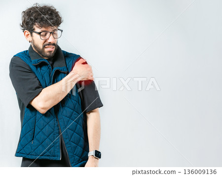 Young man with shoulder inflammation isolated. Person with pain and muscle tension in the shoulder 136009136