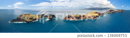 Drone aerial of Sao Lourenco Islet and sea stacks with turquoise Atlantic swells and white surf Drone aerial of Sao Lourenco Islet and sea stacks with turquoise Atlantic swells and white surf 136009753