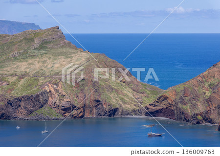 Baia dAbra coastal cliffs on Sao Lourenco Peninsula Madeira with anchored sailboats Atlantic sea Baia dAbra coastal cliffs on Sao Lourenco Peninsula Madeira with anchored sailboats Atlantic sea 136009763