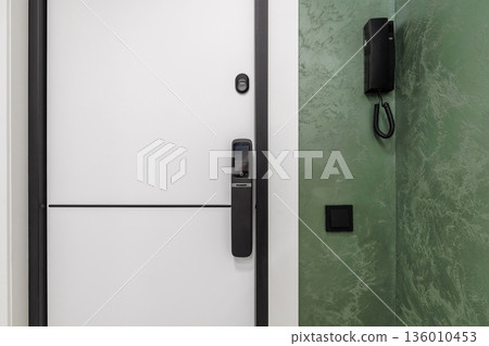Smart door lock with video intercom on white apartment door Smart door lock with video intercom on white apartment door 136010453