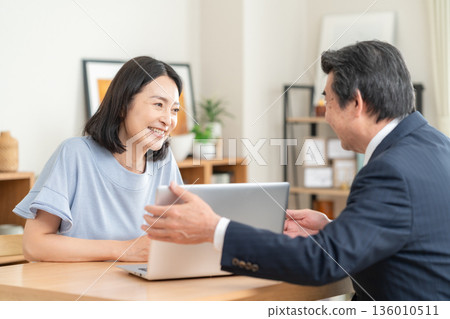 一位商人在客廳與一位女士討論生意 136010511