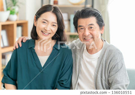 A middle-aged couple having a conversation in the living room A middle-aged couple having a conversation in the living room 136010551