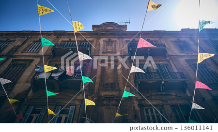 Colorful flags and historic stone building 136011141