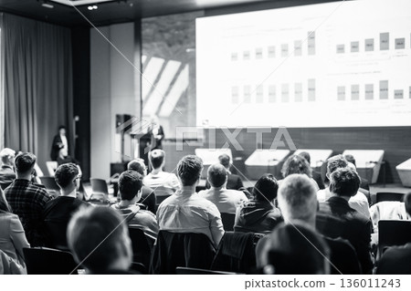 Speaker giving a talk in conference hall at business event. Black and white image 136011243
