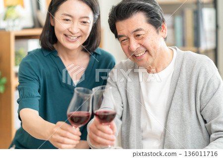 A middle-aged couple having a meal at home 136011716