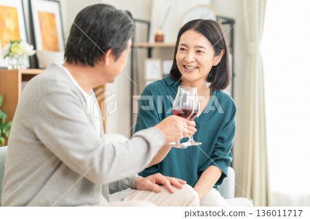 A middle-aged couple having a meal at home A middle-aged couple having a meal at home 136011717