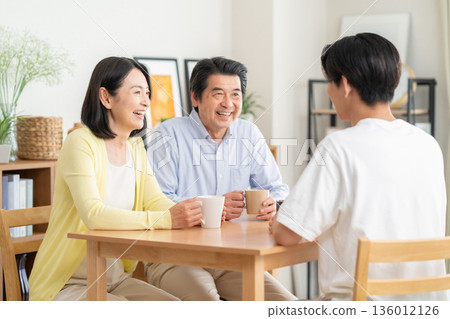 A family relaxing in the living room 136012126